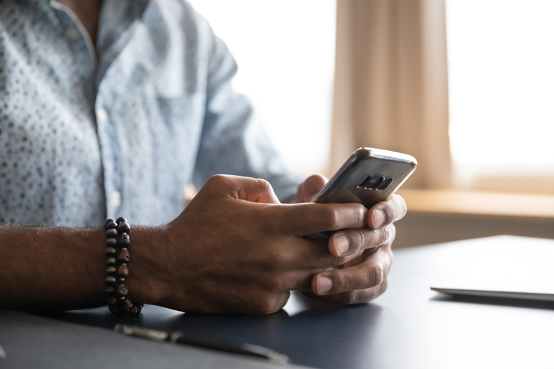 close up of mans hands holding phone